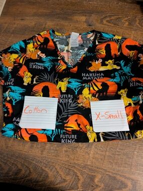 The Lion King Hakuna Matata V-Neck Scrub Top - Black with Orange & Teal Print